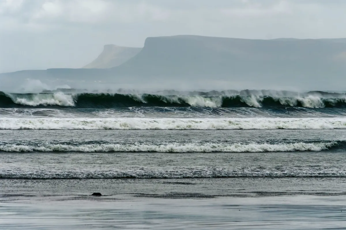 Ocean waves crashing on shore in County Sligo, Ireland — the unpredictable force that well-designed systems are built to withstand.